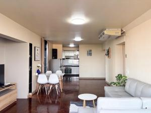 a living room with a white couch and white chairs at Bann-Kun Impact Muang Thong 2BR Condo Wi-Fi MRT Pink Near Airport DM in Nonthaburi