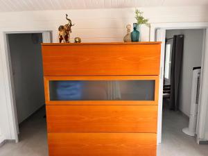 a chest of drawers with a dog on top of it at Secret Garden Chalet No. 1 in San Pietro in Bevagna