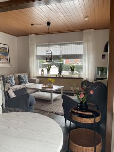 a living room with a couch and a table at Ferienhaus Anni in Bad Zwischenahn