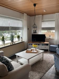 a living room with a couch and a coffee table at Ferienhaus Anni in Bad Zwischenahn