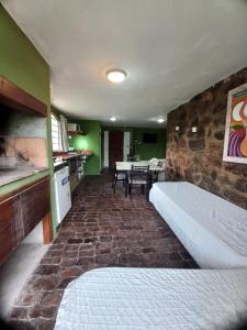 a room with a bed and a table and chairs at Tere & Tino Cabañas in Río Ceballos