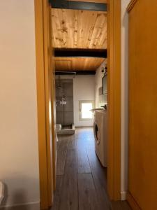 a hallway of a kitchen with a washer and dryer at U Pantanu in Syracuse +66 photos