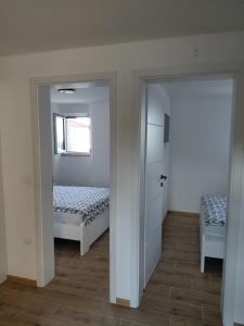 a bedroom with a bed and a window and a door at Vila Azzuro in Žusterna