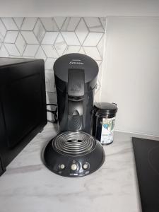 a coffee maker sitting on top of a counter at Maison Le cottage in Crosne