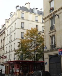 a large white building on a city street at Modern Hotel in Paris