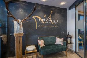 a room with a green chair and a starry wall at Hotel Alpenkönigin - ALPINE LUXURY in See