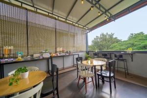 a restaurant with tables and chairs in a room at SRS Vivanta in Bangalore
