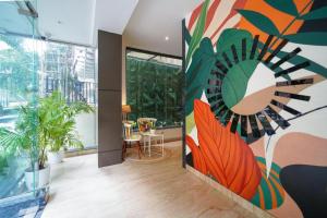 a room with a large painting on the wall at SRS Vivanta in Bangalore +11 photos
