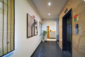 a hallway of an office with a plant on the wall at SRS Vivanta in Bangalore