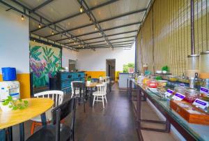 a restaurant with tables and chairs in a room at SRS Vivanta in Bangalore