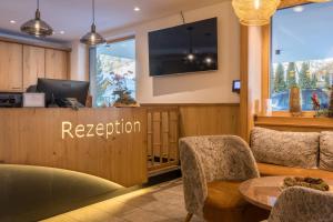 a reception area of a hotel with a reception desk at Hotel Alpenkönigin - ALPINE LUXURY in See
