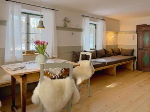 a living room with a table and a couch at Altes Zollhaus in Neukirchen +33 photos