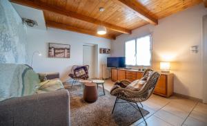 a living room with a couch and chairs at L'Orée du Bois in La Charmée