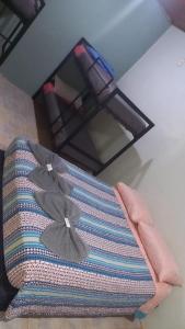 a room with a pillow and a chandelier at Hostel Park Iguazu in Puerto Iguazú