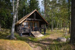 a small cabin in the woods with trees at Fishing and holiday village Merikoivula in Uusikaupunki +69 photos