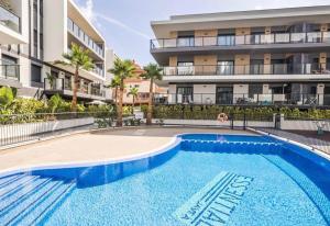 a swimming pool in front of a apartment building at Apartamento Esencia in Jávea