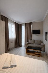 a hotel room with a bed and a couch at Urban Nest old Tbilisi hotel in Tbilisi City