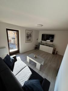 a living room with a couch and a coffee table at J&D Comfort Apartment in Cresciano
