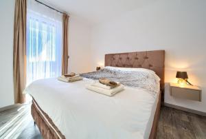 a bedroom with a bed with two towels on it at Luxury-relax residence Muraj in Kornić +27 photos