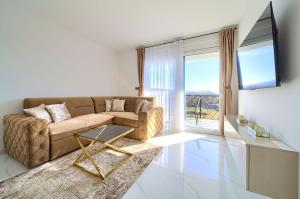 a living room with a couch and a large window at Luxury-relax residence Muraj in Kornić
