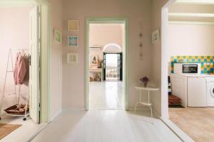 a room with a hallway with a door open to a kitchen at Aerino in Symi +15 photos