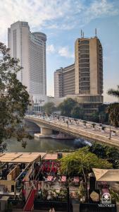 a bridge over a river in a city with buildings at Nilotique in Cairo