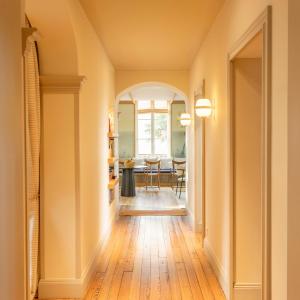 a hallway with an archway and a dining room at Hotel Saint Julien in Biarritz +61 photos