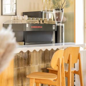 a kitchen with two wooden chairs and a counter at Hotel Saint Julien in Biarritz