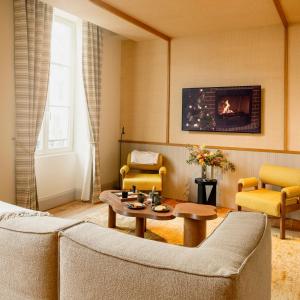 a living room with a couch and a table at Hotel Saint Julien in Biarritz