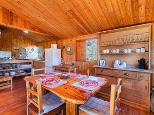 a dining room with a table and a refrigerator at Bloukrans Off-Grid Cabin in Montagu
