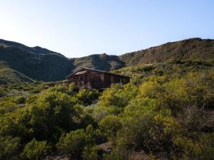 a house in the middle of the mountains at Bloukrans Off-Grid Cabin in Montagu +7 photos