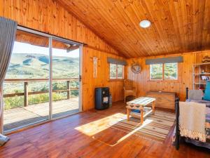 a room with a large window in a cabin at Bloukrans Off-Grid Cabin in Montagu