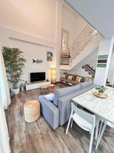a living room with a couch and a table at Dúplex Empul Brisa Marina in Los Caños de Meca