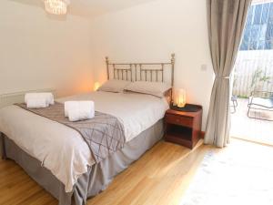 a bedroom with a bed with two pillows on it at The Baler House in Hayle