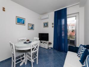 a small living room with a table and a television at Villa Supe in Supetar