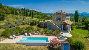 an external view of a house with a swimming pool at Villa Pigini by Villas Guide in Livade