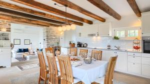 a kitchen and dining room with a table and chairs at Villa Pigini by Villas Guide in Livade