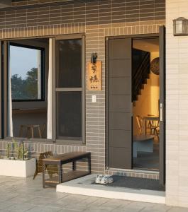 a glass door on a building with a bench at 參穗 SunSui Guesthouse in Sanxing +19 photos