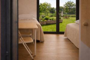 a room with a bed and a table and a window at Agriturismo Verdecielo in Padova