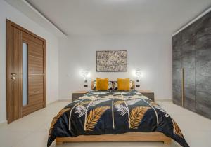 a bedroom with a large bed with yellow pillows at Gozo Getaway! Heated Jacuzzi & Views in Xagħra +26 photos