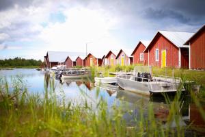 a group of boats in the water next to houses at Fisherman's cottage in Björköby