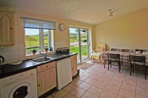 a kitchen with a sink and a dishwasher and a table at 3 Bed in Cahirciveen oc-i417 in Reenard Cross