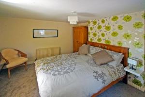 a bedroom with a bed and a chair at 3 Bed in Cahirciveen oc-i417 in Reenard Cross
