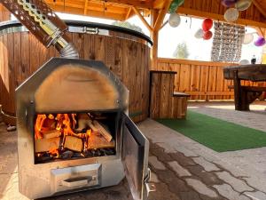 a fireplace in a patio with a table and balloons at Brzozowy Zakątek in Waśki