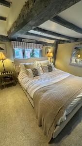 a large white bed in a room with a ceiling at Spenford House 1640 listed house Idilic Location pub walking distance in Shrewsbury +42 photos