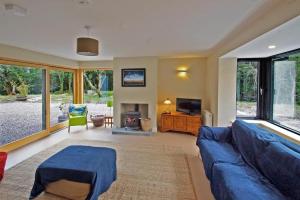 a living room with a blue couch and a fireplace at 3 Bed in Sneem oc-i136 in Sneem