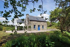 an old stone house with blue doors in a field at 3 Bed in Sneem oc-i136 in Sneem