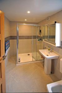 a bathroom with a shower and a sink at 3 Bed in Sneem oc-i136 in Sneem +12 photos