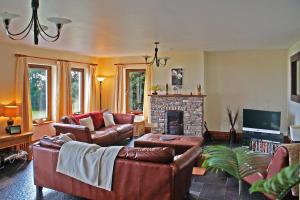 a living room with leather furniture and a fireplace at 4 Bed in Inch oc-i183 in Anascaul