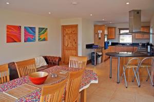 a kitchen and living room with a table and chairs at 4 Bed in Inch oc-i183 in Anascaul